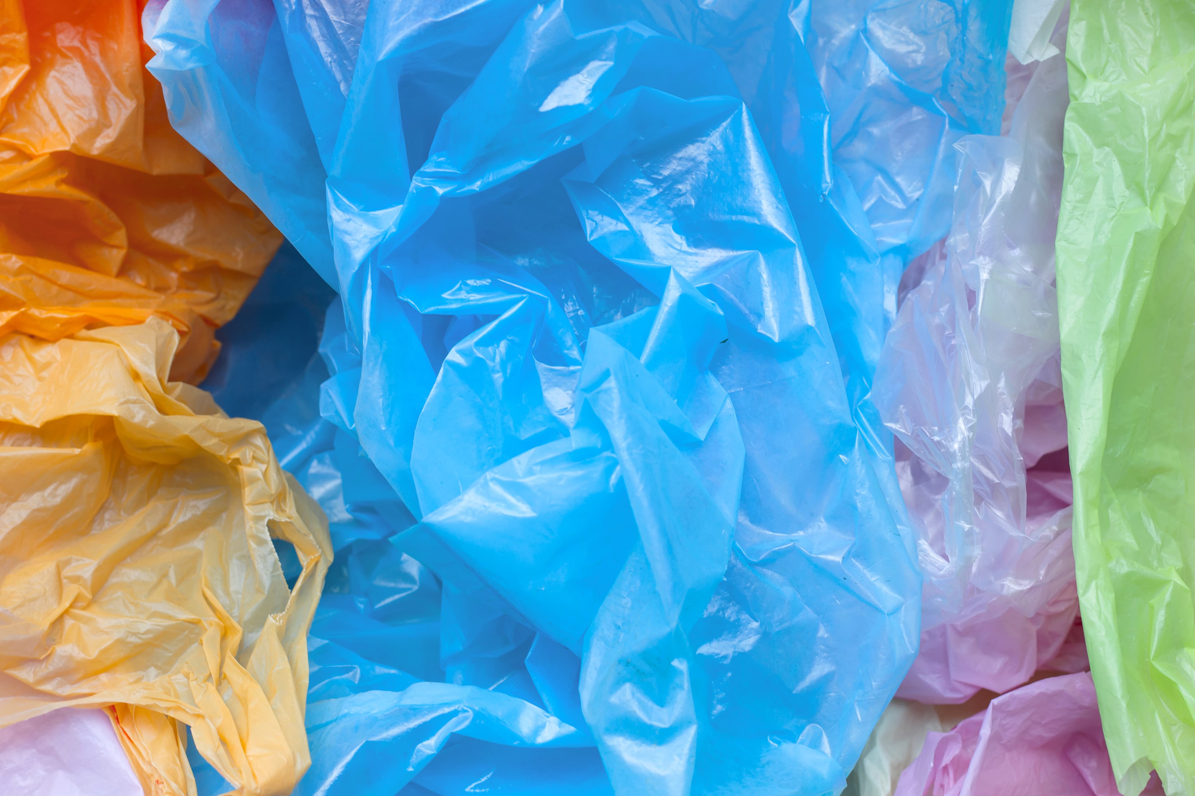 Crumpled plastic bags in blue, yellow and pink