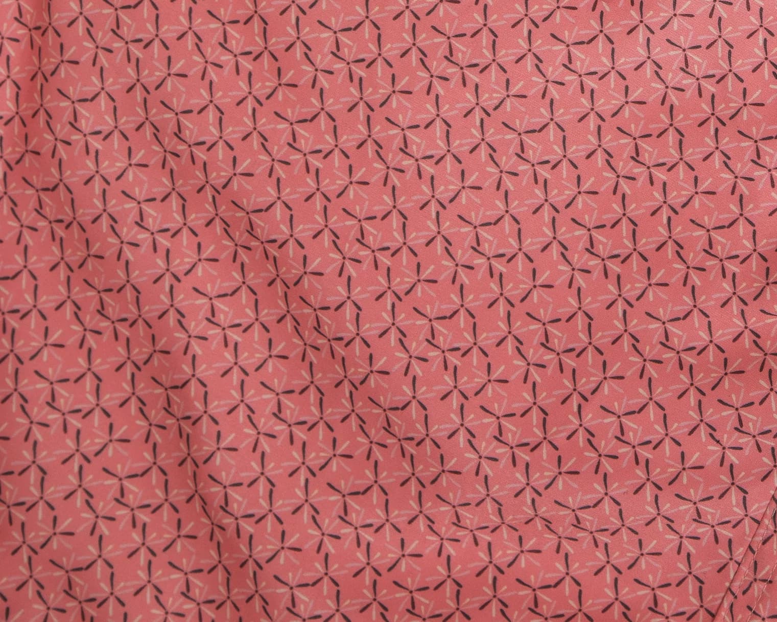 Pink fabric with a dark starburst print