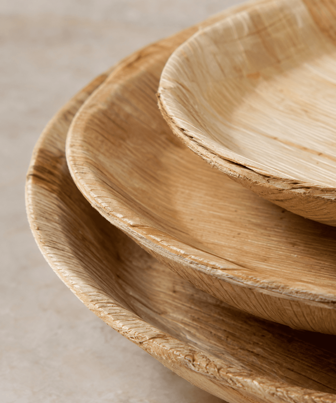 A stack of pressed areca leaf plates